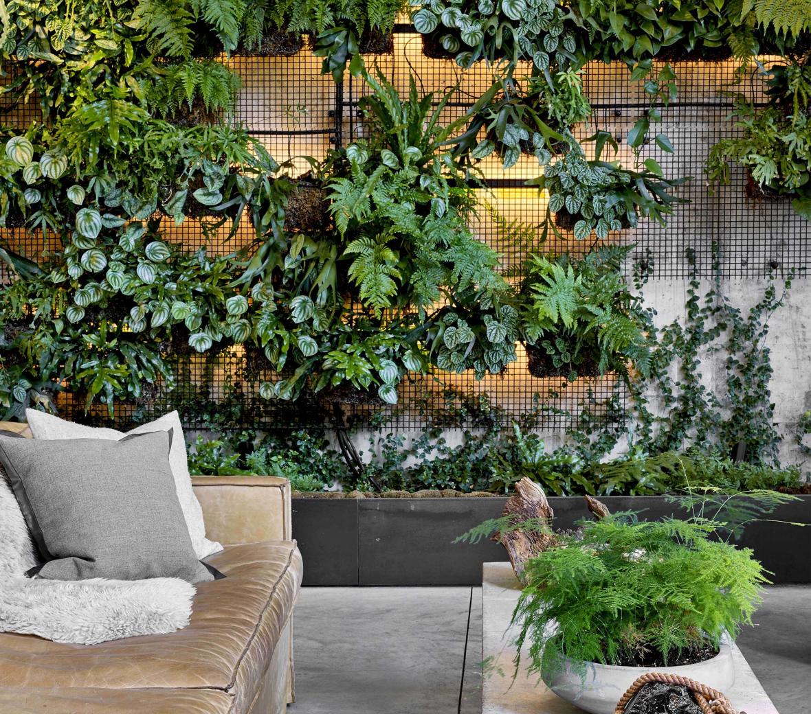 A lounge area with a wall decorated with greenery