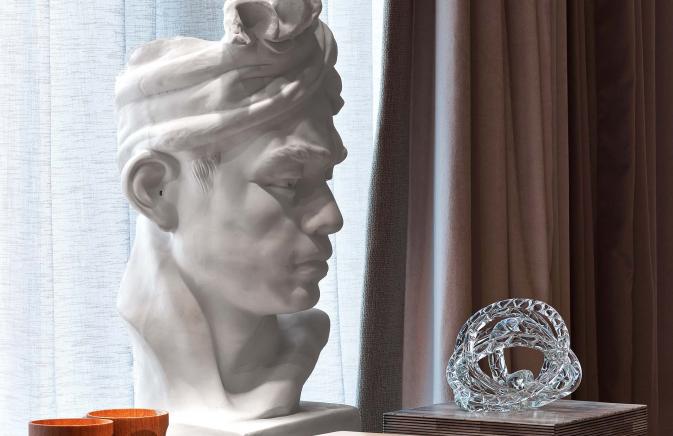 A decorative bust on a writing desk